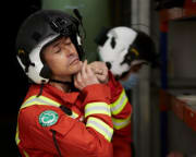 a picture of a member of air ambulance crew putting their flight helmet on